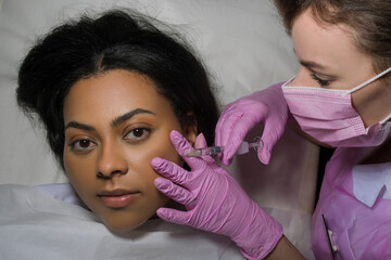 Woman receiving injection in medical practice