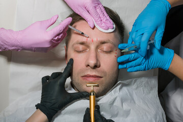 Spa Salon: Young Beautiful man Having Different Facial Treatment