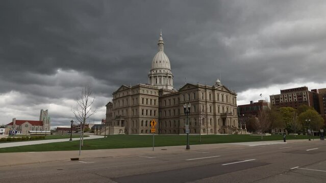 Michigan State Capitol building in Lansing, Michigan with timelapse footage of dark clouds passing by and cars.