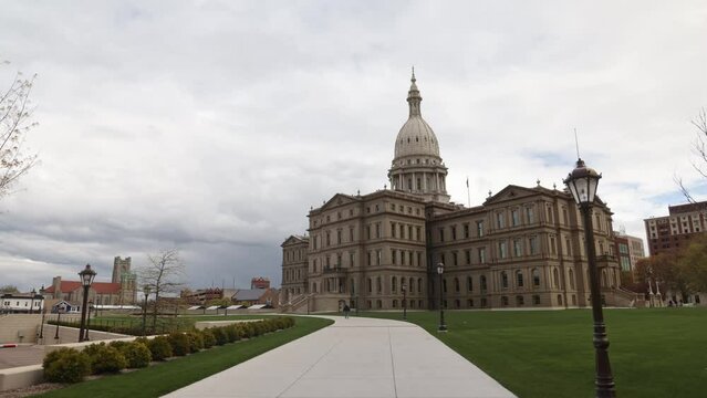 Michigan State Capitol building in Lansing, Michigan with timelapse footage of dark clouds passing by.