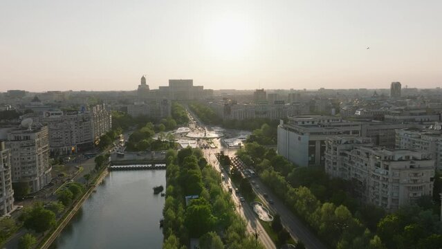 Aerial flyover city of bucharest with busy roundabout during golden hour