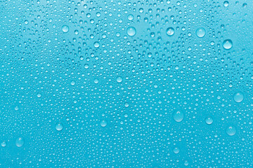 Naklejka na ściany i meble Water drops on color background, top view