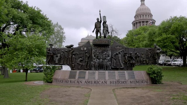 Texas African American History statue on the grounds of the Texas state capitol building in Austin, Texas with gimbal video walking forward.