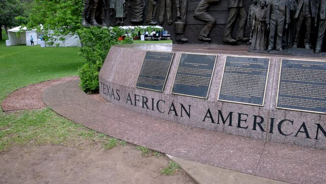 Texas African American History statue on the grounds of the Texas state capitol building in Austin, Texas with gimbal video panning left to right of base.