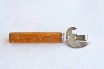 A can opener lies on a white background