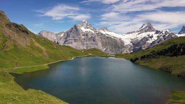 Aerial : Bachalpsee lake in Swiss alps of Grindelwald, Switzerland.
panorama summer view of alpine mountain lake with view on snow capped Schreckhorn, Wetterhorn and Finsteraarhorn peaks backdrop.