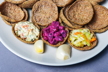 Rye bread toasts on a plate on a gray background