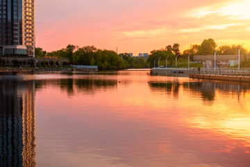 Sunset on the embankment in Kyiv. Poznyaki Park near the River Mall.