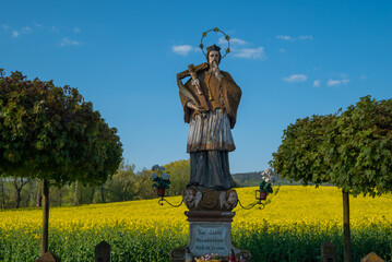 Rapeseed field with the statue of Saint John of Nepomuk