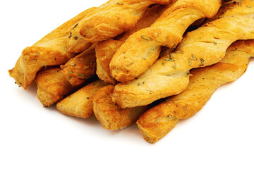 Sticks of buttery yeast dough on a white background