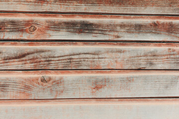 An aged hardwood wall background. Wooden red planks with texture of a natural tree.