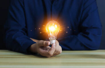 Light bulb in hand businessman, idea and creativity, personality, identity, distinctive, creative...
