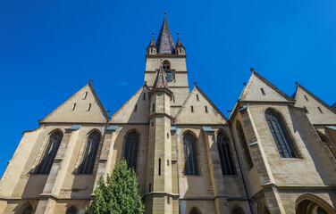 Fototapeta na wymiar Facade of Lutheran Cathedral of Saint Mary in Old Town of Sibiu, Romania