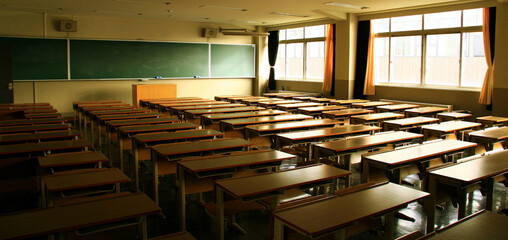 The setting sun shines into an empty after-school classroom.