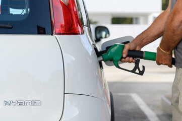 unrecognizable person at Gas Station - hybrid car