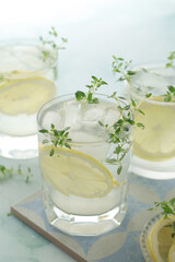 Glasses with lemon and thyme refreshing drink
