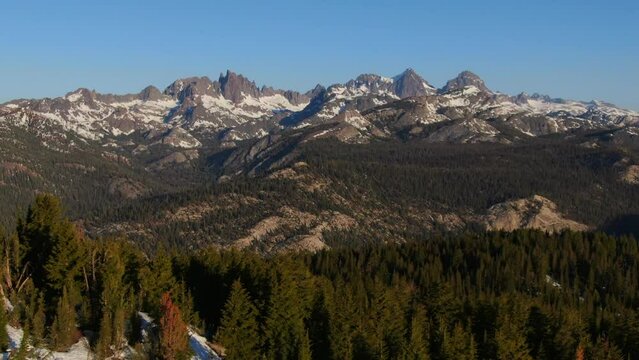 Aerial Cinematic drone early sunrise Spring lack of snow Mammoth Mountain California Sierra Nevadas mountain range landscape forward movement