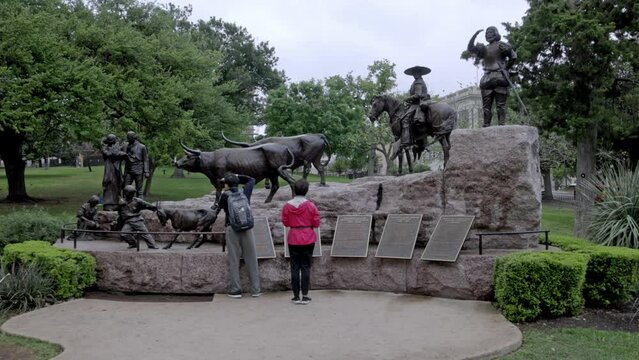 Tejano statue on the grounds of the Texas state capitol building in Austin, Texas with gimbal video walking forward.