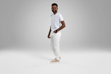 Fototapeta na wymiar Handsome young african american guy posing in studio - isolated