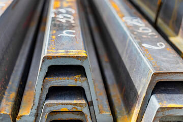 Rolled metal profile in a metal products warehouse. Steel profiles for the production of metal structures, profiles, rolled metal products for construction.