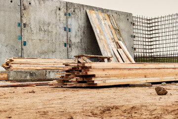 Monolithic reinforced concrete work at the construction site. Boards for the construction of formwork. Erection and reinforcement of reinforced concrete walls of the building.