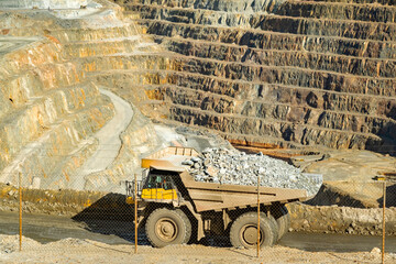 Loaded dump truck driving along Cerro colorado, the largest active open pit mine in Europa producing copper, silver and several other metal ores