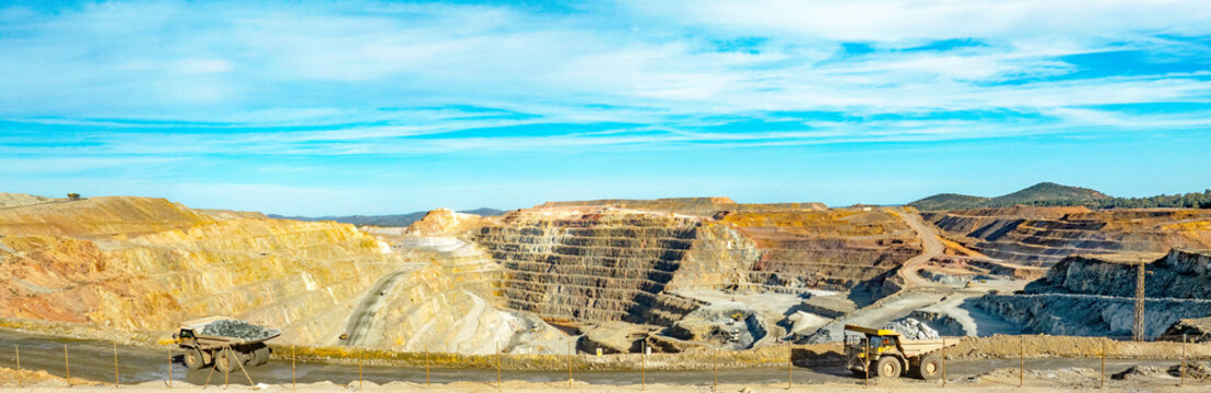 Dump trucks driving along Cerro colorado, the largest active open pit mine in Europa producing copper, silver and several other metal ores