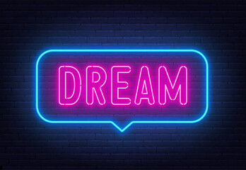 Dream neon sign in the speech bubble on brick wall background.