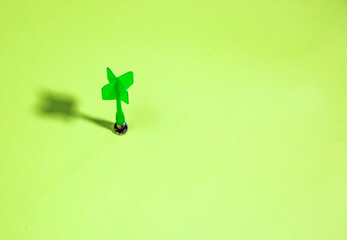 Green dart on a green background. purpose succes concept