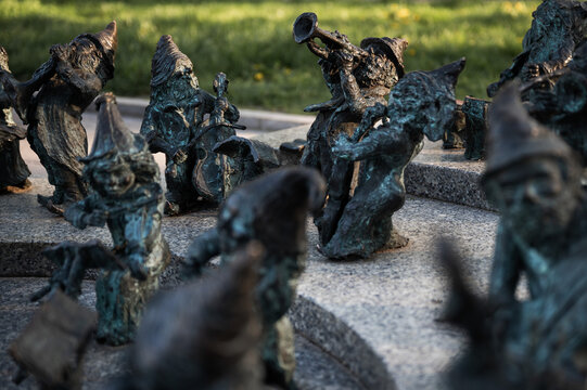 WROCLAW, POLAND - APRIL 22, 2023: Statue of dwarves representing philarmonic orchestra of Poland located in front of the building National Forum of Music.