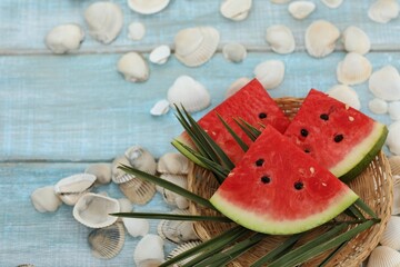 Watermelon cut into slices, on a blue background, sea shells, sea style, sea, rest, travel, red ripe, berry, tower culture, healthy food, sweet, dessert, background, day, holiday, text, write, happine