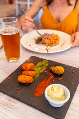 Having dinner in a restaurant on the beach on vacation at sunset, eating seafood