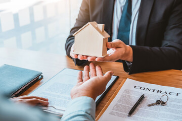 Sale Agent handshake with woman customer and sign agreement documents for realty purchase after successful loan contract