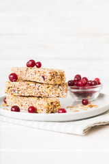Various granola bars on table background. Cereal granola bars. Superfood breakfast bars with oats, nuts and berries, close up. Superfood concept