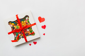 Valentine day composition: sweet candy, with gift boxes with bow and red felt hearts, photo template, background. Top View with copy space