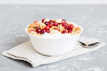 Healthy breakfast food with granola, yogurt, fruits and nuts. Dessert parfait with dried fruits for breakfast