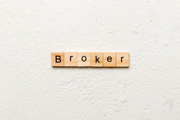 broker word written on wood block. broker text on cement table for your desing, concept
