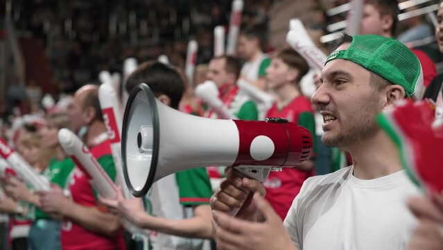 Angry man scream megaphone sport stadium. Crazy mad fan shout bullhorn close up. Anger aggressive male cheer team. Furious person yell loudspeaker. Evil guy loss win goal. Crowd watch game cup match