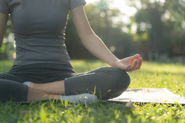 woman practicing meditate on the park. Asian woman doing exercises in morning. balance, recreation,...