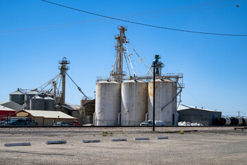Fototapeta na wymiar Vintage big concrete silos on a blue sky