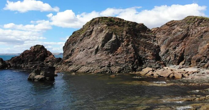 Aerial forward shot of rocks at Hope Cove South Devon England UK