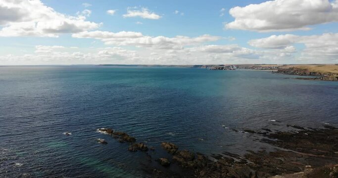 Aerial panning right shot highlighting the beautiful coastline and rock formations at Thurlestone South Devon England