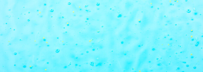 Cosmetic gel close-up with oxygen bubbles. Textured background with microbrushes in cosmetics. Moisturizing skin serum with vitamins and collagen.