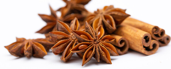 Star anise and cinnamon sticks on a white background isolated. Indian spices close up. Medicinal herbs and spices.