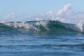 Shore break wave on a beautiful sunny day.