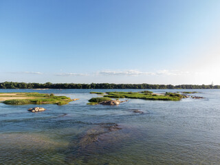 beautiful wide green river with forest banks