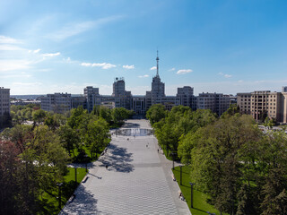 Aerial Derzhprom building with fountain and green park in spring on Freedom Square in Kharkiv city center, Ukraine. Constructivist architecture