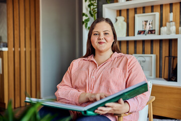 Portrait of a beautiful adult curvy woman with a family photo album in her hands.
