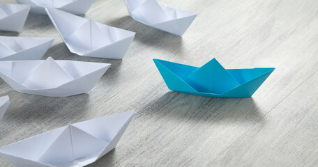 Blue and white paper boats. Business concept