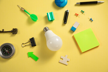 Fototapeta na wymiar Light bulb with a business supplies. Business. Creative idea